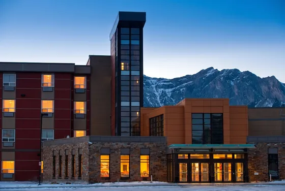 Stoney Nakoda Resort & Casino at dusk, mountains behind